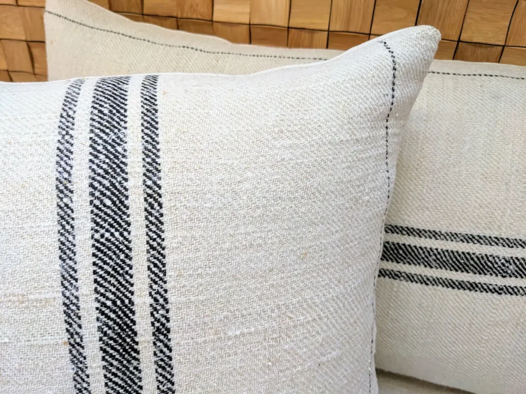 Square and lumbar grain sack cushions, oatmeal handspun hemp, diagonal twill weave, centered stripe group, black woven lines, restored and hand-sewn in Transylvania
