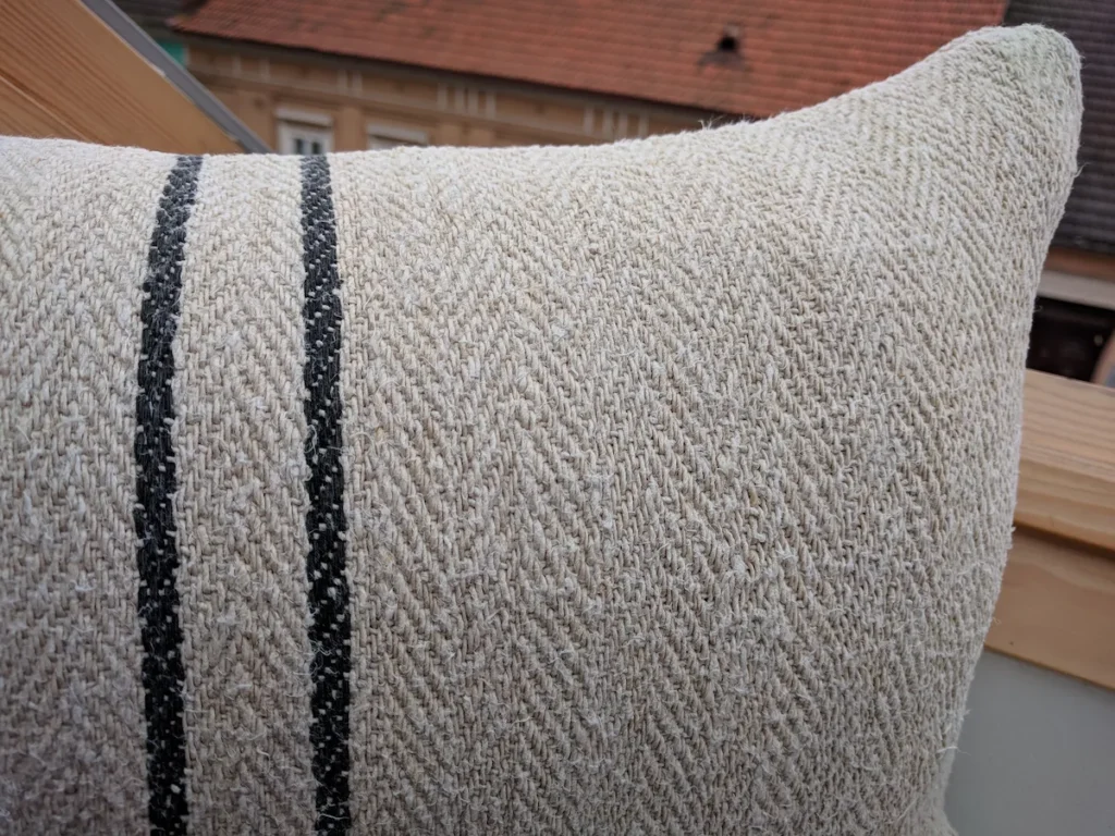 Lumbar grain sack pillow, oatmeal handspun hemp, herringbone twill weave, centered stripe group, two black woven lines, restored and hand-sewn in Transylvania