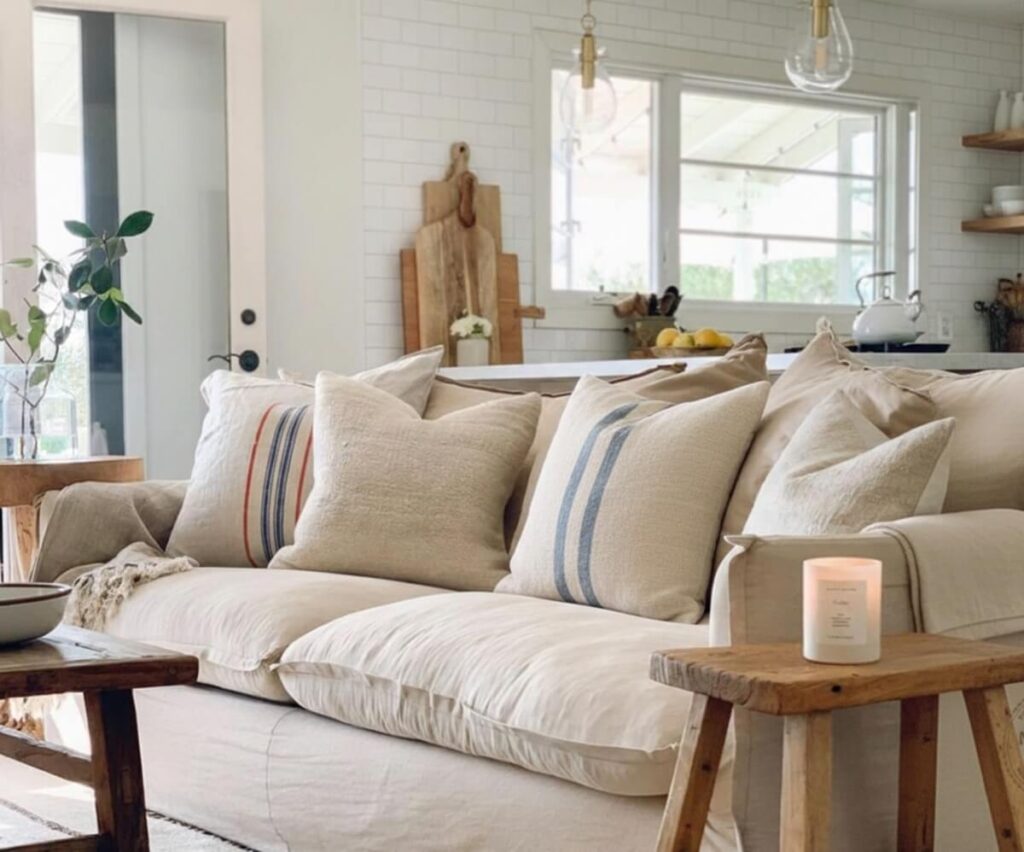 Beautiful farmhouse interior design featuring authentic Transylvanian grain sack pillows on styled sofa